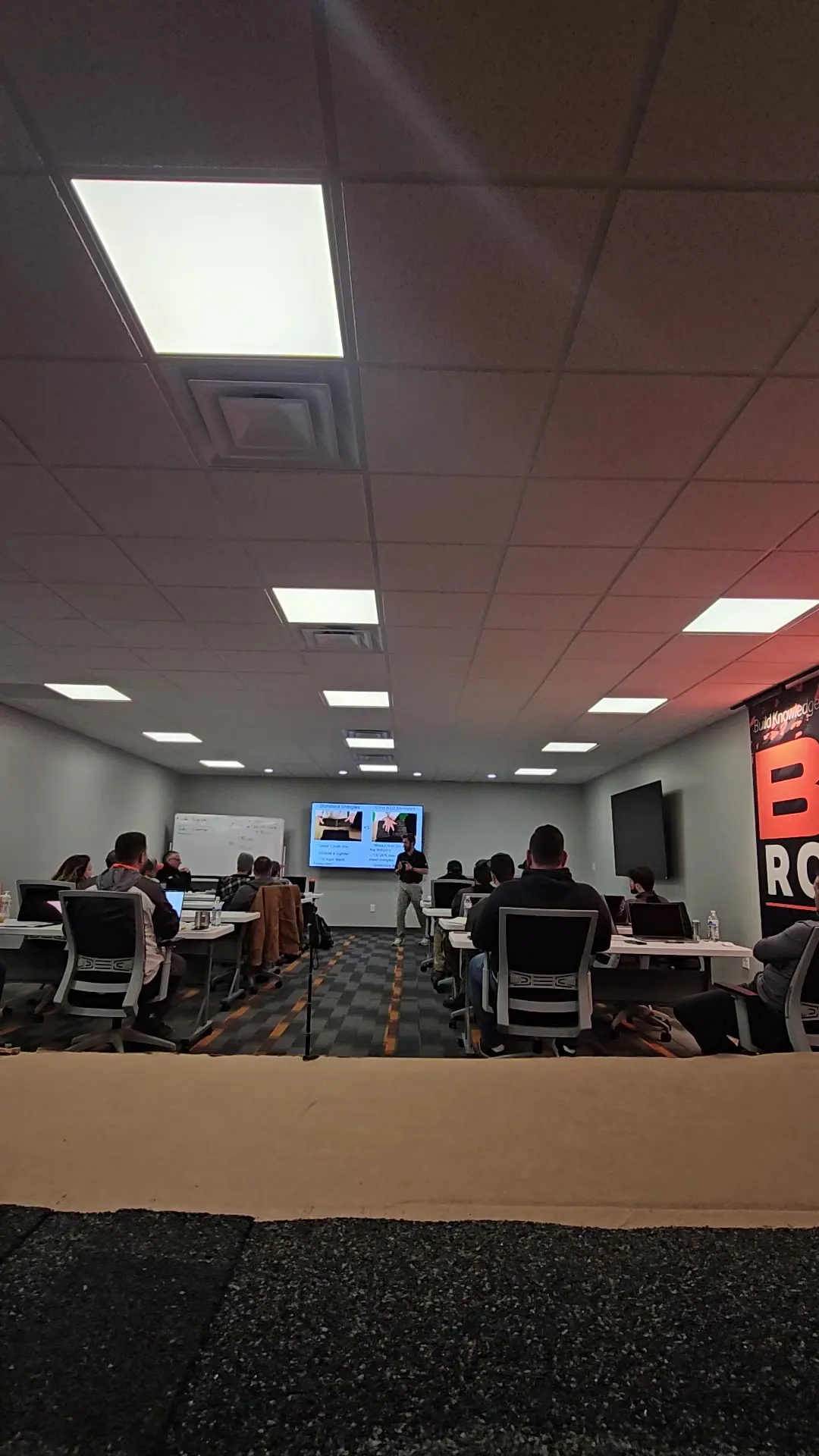 BCS Roofing team seated in rows during a training session