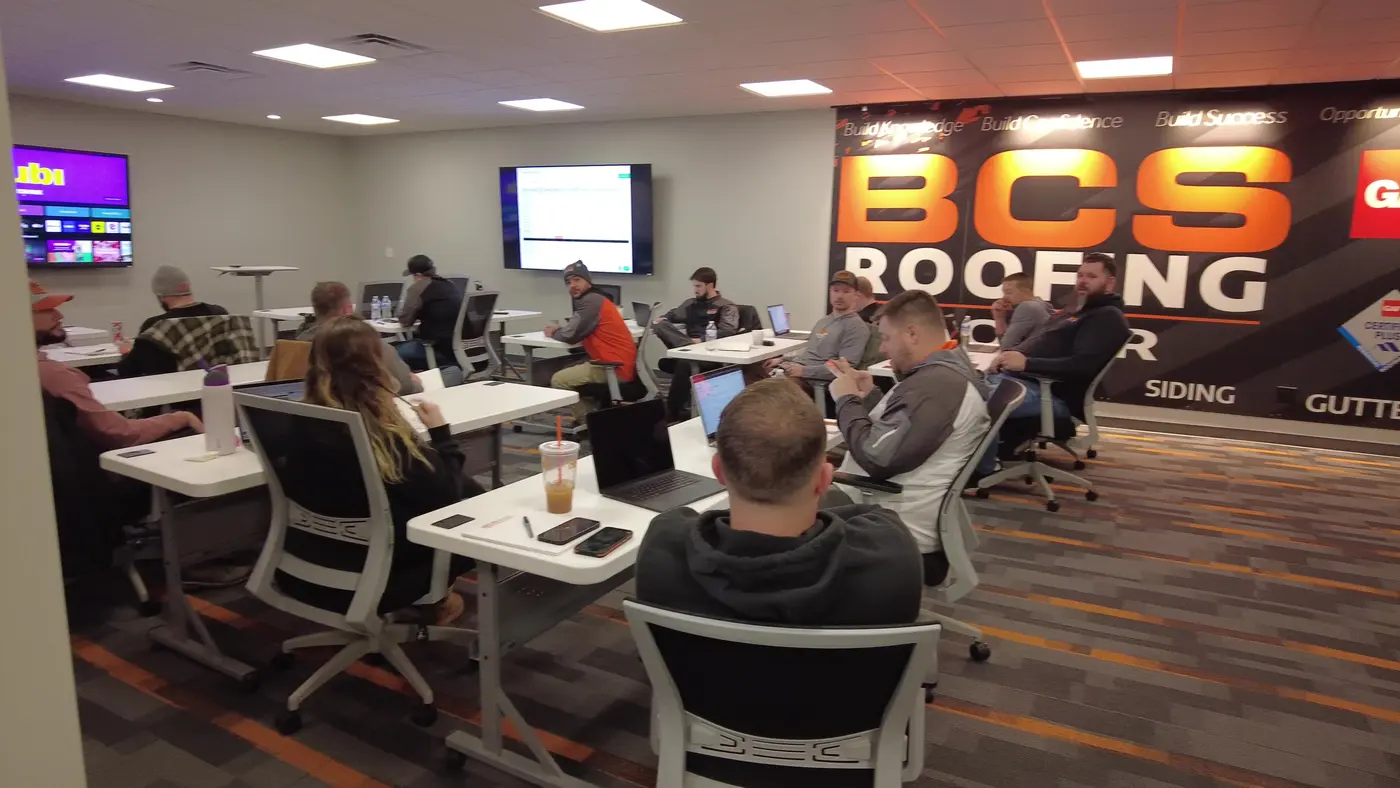 Noah training a room of BCS Roofing staff at their desks