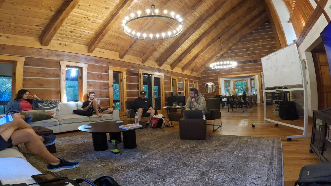 Retreat attendees in a lodge great room during the Purpose Pulse session