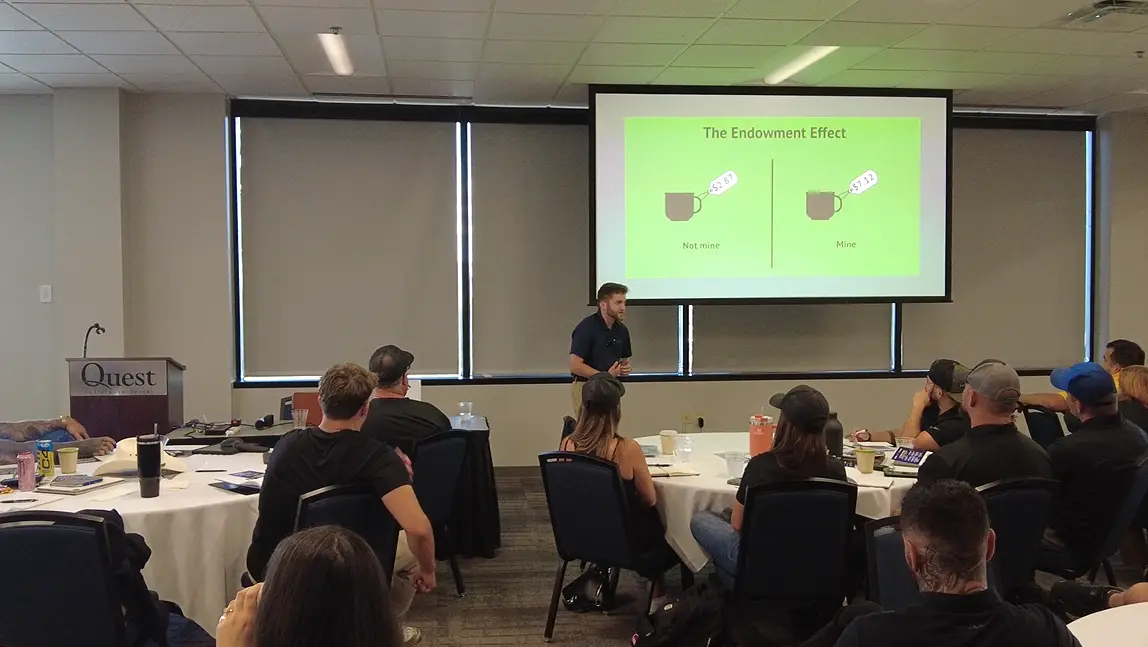 Noah presenting an Endowment Effect slide to a room of contractors