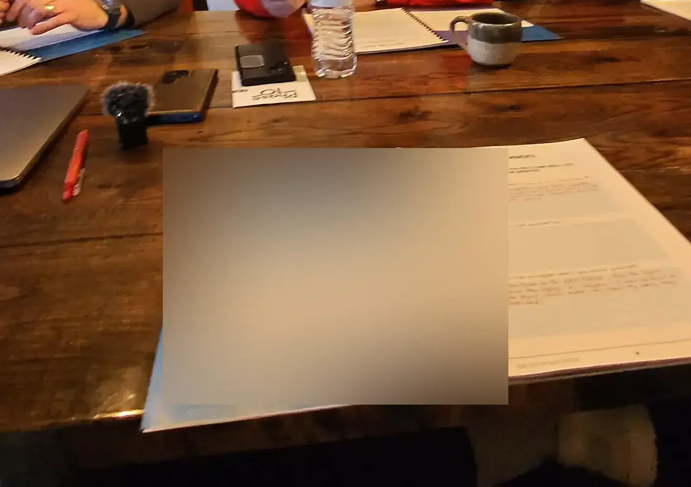 An open workbook on a table during a sales retreat session